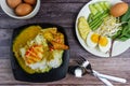 Thai rice noodles in grab curry sauce with vegetable and boiled eggs on wood table Royalty Free Stock Photo