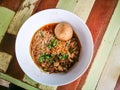 Thai Rice vermicelli noodles soup with beef and one big beef ball in white bowl on wooden table. Royalty Free Stock Photo