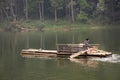 Thai rower waterman rowing bamboo rafts in Pang Ung lake for service travelers people travel visit Pang Oung or Switzerland of