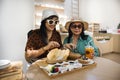 Thai senior mother and young daughter women travel visit and relax in modern dining room of classic cafe coffee shop restaurant