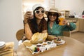 Thai senior mother and young daughter women travel visit and relax in modern dining room of classic cafe coffee shop restaurant