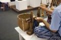 Thai senior woman people using spinning cotton thread machine for show traveller at shop