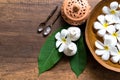 Thai spa composition treatments aroma therapy with candles and Plumeria flowers on wooden table Royalty Free Stock Photo