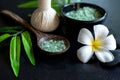 Thai spa composition treatments aroma therapy with candles and Plumeria flowers on wooden table close up. Royalty Free Stock Photo