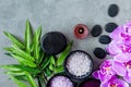 Thai Spa. Top view of hot stones setting for massage treatment and relax with purple orchid on blackboard with copy space. Green Royalty Free Stock Photo