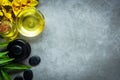 Thai Spa. Top view of hot stones setting for massage treatment and relax with yellow orchid on concrete blackboard with copy space Royalty Free Stock Photo