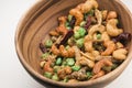 Thai spicy mixed nuts in wooden bowl Royalty Free Stock Photo