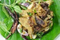 Thai spicy slice grilled pork salad on banana leaf