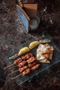 Thai spicy tender pork barbecue skewers with grill pineapple and Papadum crispy chips in glass plate Royalty Free Stock Photo