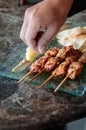 Thai spicy tender pork barbecue skewers with grill pineapple and Papadum crispy chips in glass plate Royalty Free Stock Photo