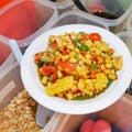 Thai street food, Spicy fruits salad mixed with corn and tomato on white plate-soft focus Royalty Free Stock Photo