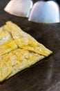 Thai street food-traditional Thai pancakes fried on a pancake close-up. with banana, chocolate, nut paste