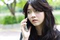 Thai student teen beautiful girl Answer the phone and smile Royalty Free Stock Photo