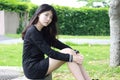 Thai student teen beautiful girl Black Dresses relax in park Royalty Free Stock Photo