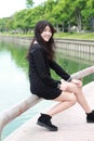 Thai student teen beautiful girl Black Dresses relax and smile. Royalty Free Stock Photo