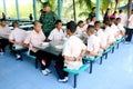 Thai students are arm crossing before eating lunch in the discipline conduct at Paknampran school, Paknampran, Pranburi, Thailand Royalty Free Stock Photo
