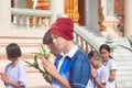 Thai students wear white clothes making a merit at the temple in Pranburi, Thailand July 21,2017