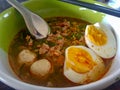 Thai style chopped pork noodle garnished with pork balls and half-cutted boiled egg Royalty Free Stock Photo