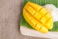 Thai style dessert, glutinious rice with mango on banana leaf an