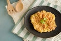 Thai-style Egg Omelette, isolated served in a white plate with coriander leaves as garnish.Thai Asian style food.