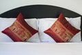 Thai style elephant pattern pillows on bed