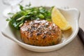 Thai style fishcakes with spicy soy glaze, salad and lemon wedge