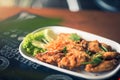 Thai style fried chicken wings on a round white plate on a wood table Royalty Free Stock Photo