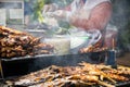 Thai style Isaan street food vendor cart,grilled chicken,catfish and grilled chicken liver on a charcoal stove with smoke at Royalty Free Stock Photo