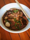 Thai style noodle soup, Boat culture noodles style. on wooden ba