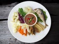 Thai style shrimp paste spicy dip served with mixed vegetables and deep fried short-bodied mackerel.