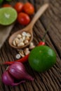 Thai style spicy food, Som Tum food concept, props decoration Garlic, lemon, peanuts, tomatoes, and shallots on wood table