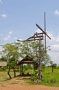 Thai style windmill with hut in countryside Royalty Free Stock Photo