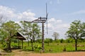 Thai style windmill with hut in countryside Royalty Free Stock Photo
