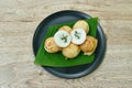 Thai sweetmeat baking coconut pudding topping slice spring onion in banana leaf on dish Royalty Free Stock Photo