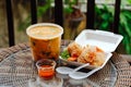 Thai takeaway food. Tom Kha soup and fried shrimp in batter Royalty Free Stock Photo