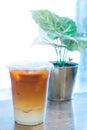 Thai tea and fresh milk mixed with ice in the plastic cup at the coffee shop in Thailand ready serve to clients. Ice Thai tea is Royalty Free Stock Photo