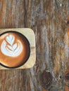 Thai tea latte art in Black cup on wooden tray with natural light. Favorite tea in Thailand. Royalty Free Stock Photo