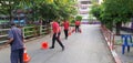 Ratchaburi, Thailand on February 2022 - Thai teachers and school officer preparing traffic cone before schoo open in the morning.