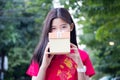 Thai teen beautiful girl in Chinese dress, happy new year and give gift, relax and smile. Royalty Free Stock Photo