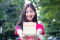 Thai teen beautiful girl in Chinese dress, happy new year and give gift, relax and smile. Royalty Free Stock Photo