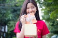 Thai teen beautiful girl in Chinese dress, happy new year and give gift, relax and smile. Royalty Free Stock Photo