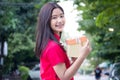 Thai teen beautiful girl in Chinese dress, happy new year and give gift, relax and smile. Royalty Free Stock Photo