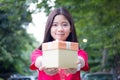 Thai teen beautiful girl in Chinese dress, happy new year and give gift, relax and smile. Royalty Free Stock Photo