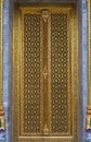 Thai Temple carving door with golden decoration Royalty Free Stock Photo