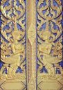 Thai temple door golden angle sculpture Royalty Free Stock Photo