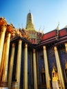 Thai temple graced with elaborate gilded and azure columns, a lofty pinnacle, and a crimson roof adorned with golden