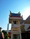 Thai temple under blue sky with building background