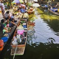 Thai traditional boats sell items in a floating market