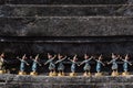 Thai traditional dancing dolls near old concrete wall in Thai temple for redeem a vow to a god