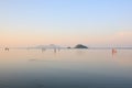 Thai traditional fisherman and family in the sea under the sunrise. Royalty Free Stock Photo